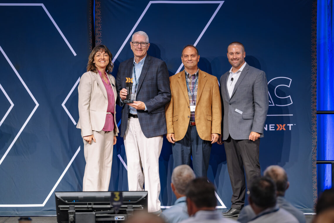 Image of Tom and Dennis of Apex with two ADAC receiving a collaboration award from two employees from ADAC.