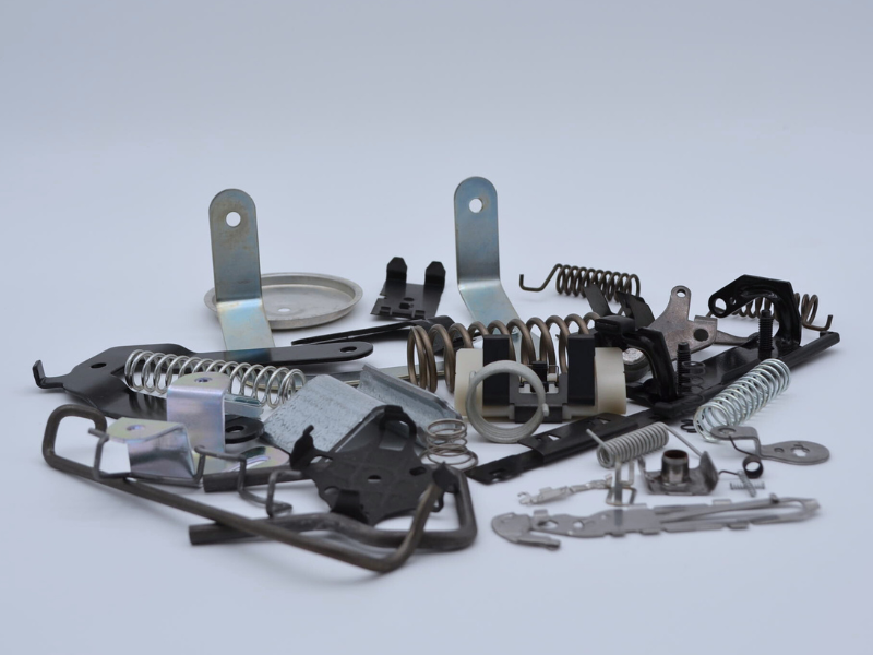 Photo of products manufactured at Apex gathered together in a collection. Includes springs, stampings, and wire forms.