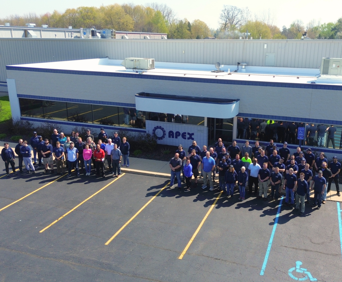 Photo of the entire Apex team in front of the main plant front entrance in Grand Rapids MI.